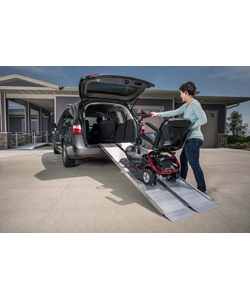EZ Access® SUITCASE® Singlefold Wheelchair or Scooter Ramp - Shown in use with a mini van (with optional top lip extension)